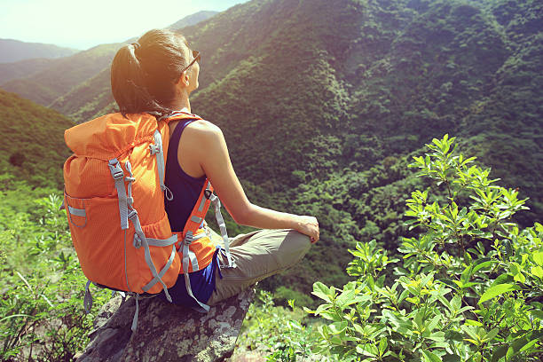 istock young woman backpacker enjoy the view on mountain peak 584743586