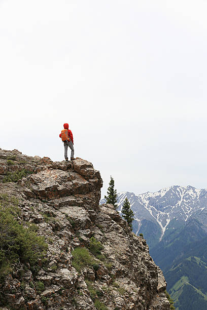 istock successful woman backpacke hiking  on mountain peak 584745234