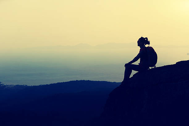 istock young  woman hiking on mountain peak cliff 584745272