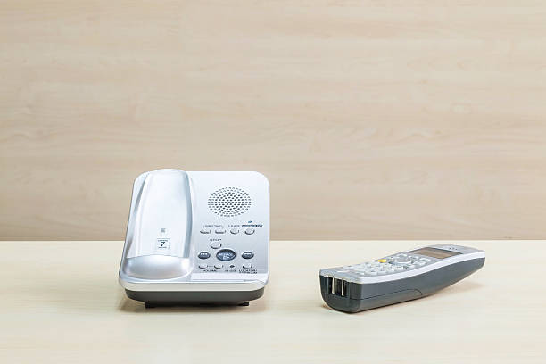 istock Closeup gray phone on blurred wooden desk 584746336
