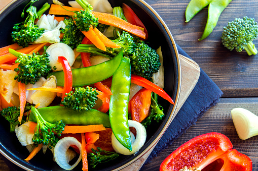 Healthy stir fried vegetables in the pan and ingredients close up