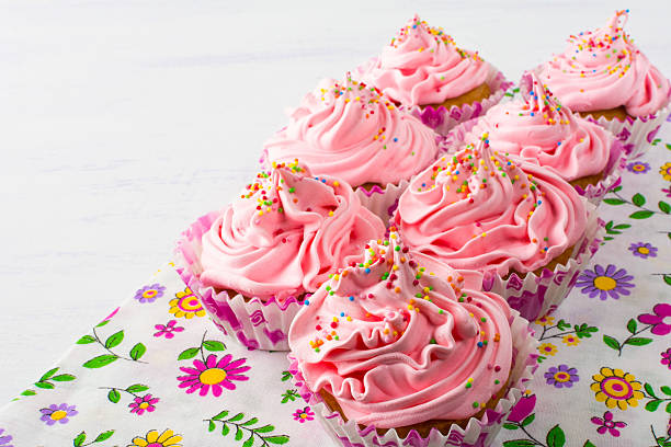 istock Pink cupcakes  on floral napkin 584748046
