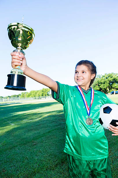 istock Excited soccer champion holds trophy 584751924