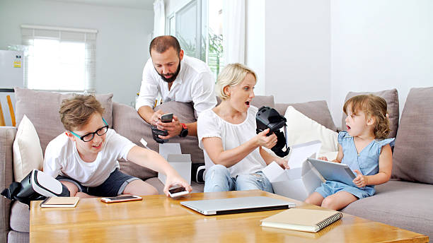 istock Family at home playing with virtual reality headsets. VR. 584752014