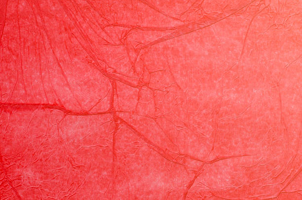 istock creased red tissue paper background 584752112
