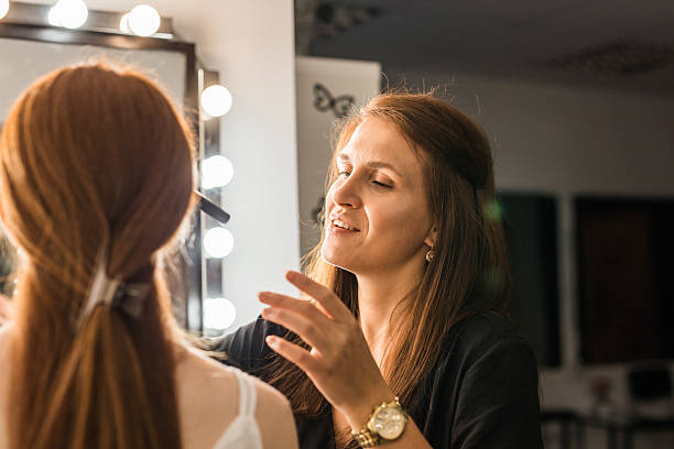 istock Make-up artist in the studio doing makeup beauty girl 584752574