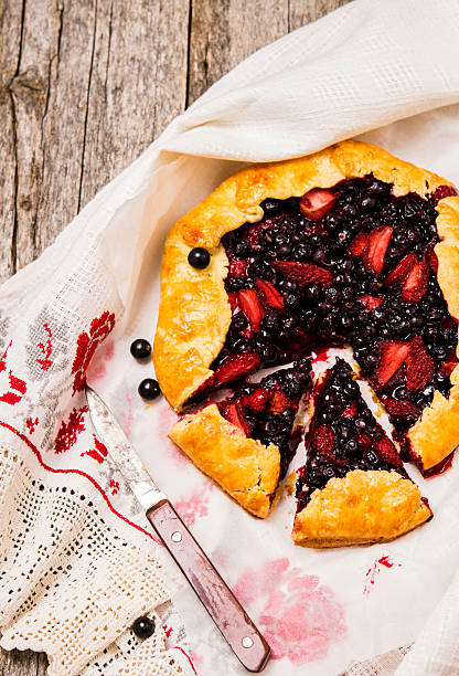 istock Rustic tart with strawberries and black currants 584753248