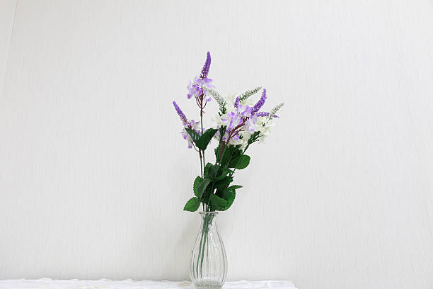 istock Plastic flowers in a vase on a dark gray background 584753336