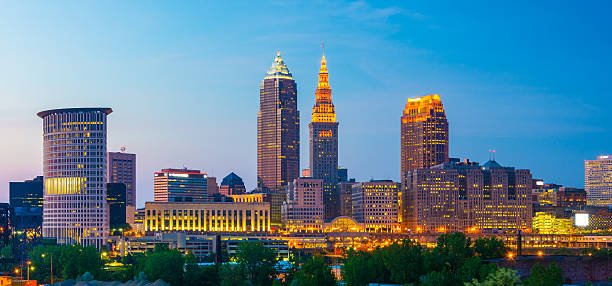 Cleveland Skyline Panorama at Dusk Downtown Cleveland skyline at dusk, panorama style, featuring Key Tower and Terminal Tower in the middle. terminal tower stock pictures, royalty-free photos & images