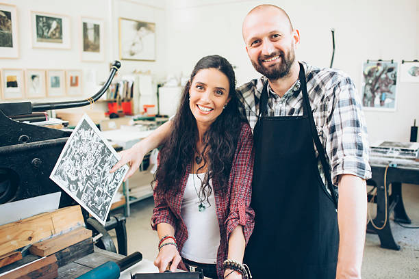 istock Portrait of smiling lithograph workers at printing house 584754018