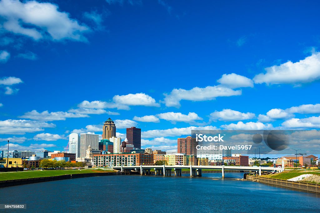 Des Moines skyline with puffy clouds and river Downtown Des Moines skyline and Martin Luther King Jr. Parkway bridge, with a sea of puffy clouds in the background and the Des Moines River in the foreground. Des Moines - Iowa Stock Photo