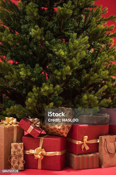 Christmas Tree With Gifts On Red Background Stock Photo - Download Image Now - Backgrounds, Box - Container, Celebration