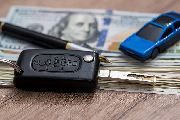 istock car key with pen and dollar 584757002