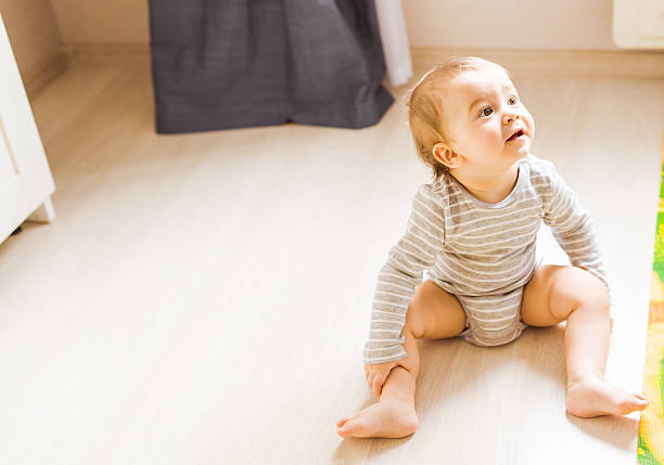istock Baby boy plays in his room. 584757114