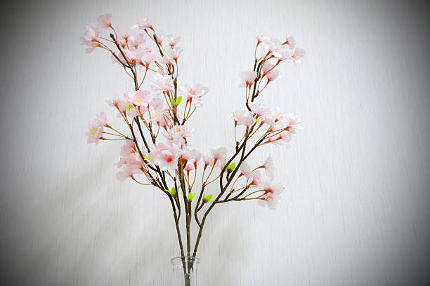 istock Plastic flowers in a vase on a dark gray background 584757516