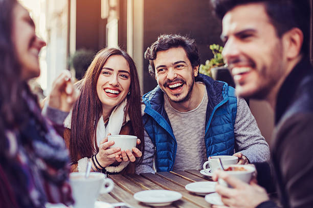 istock Friends laughing and drinking tea and coffee 584757682
