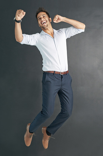 Studio shot of a happy businessman jumping for joy