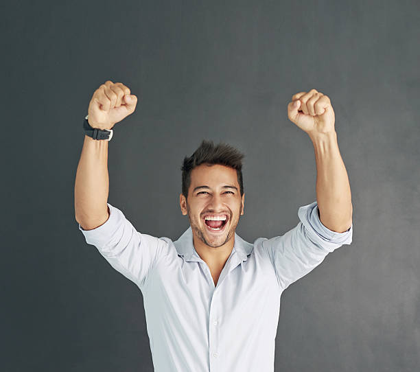 Doing his victory dance Studio shot of a happy businessman celebrating a victory exhilaration stock pictures, royalty-free photos & images