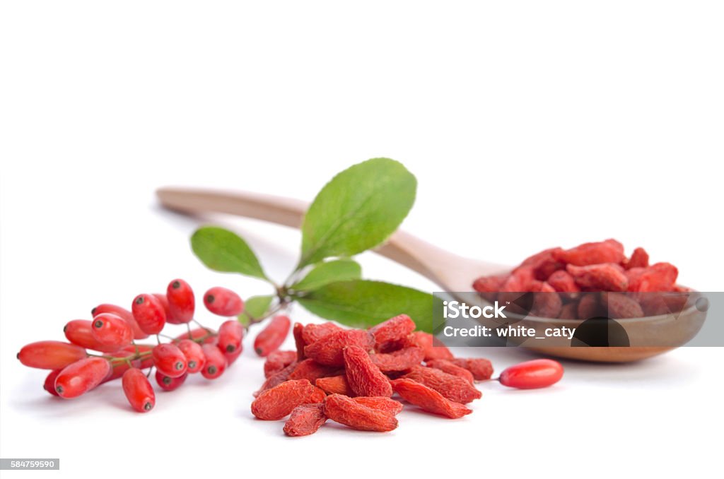 barberries and goji berries isolated on white background Alternative Therapy Stock Photo