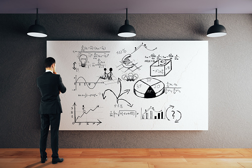 Businessman looking at whiteboard with business sketch. 3D Rendering