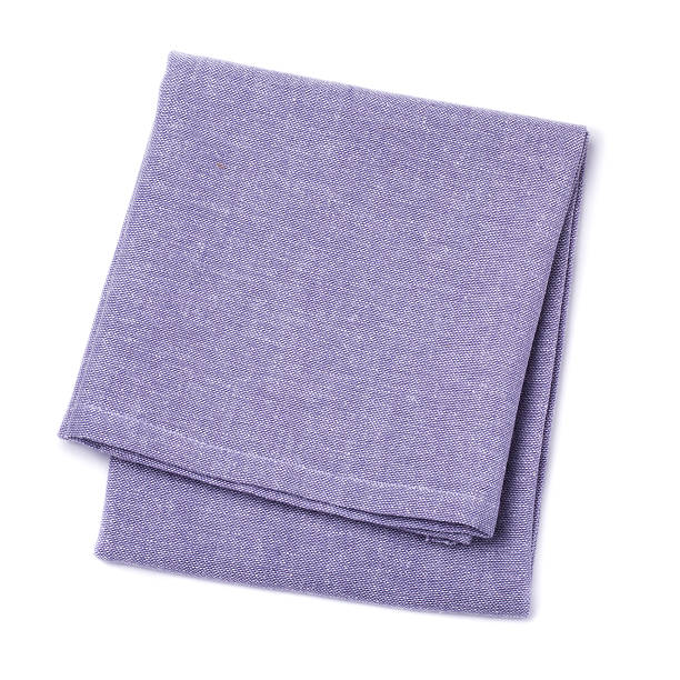 Folded napkins violet color on white background, top view stock photo