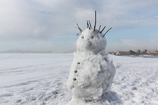 istock The cheerful incomplete snowman standing against the sky 584762816