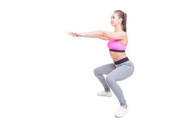 istock Fit girl working out doing squats with hands up 584763540