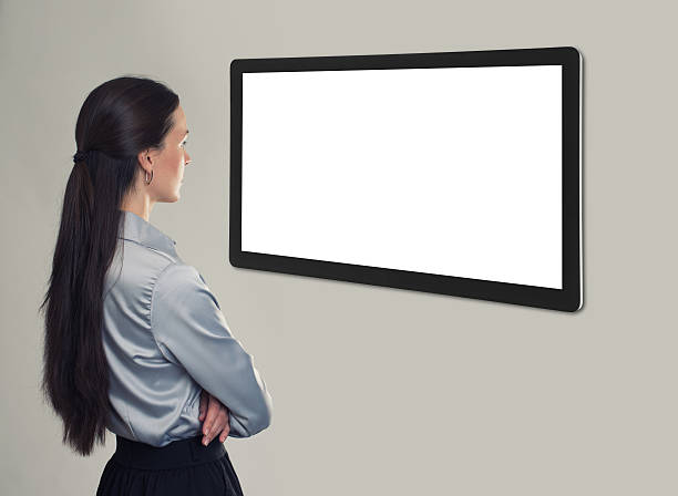 istock business woman looking at blank screen. Rear view 584763592