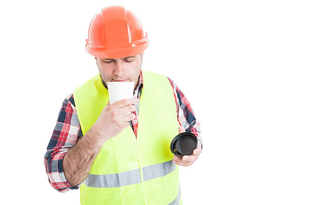 istock Young builder enjoying the flavor of fresh coffee 584764370