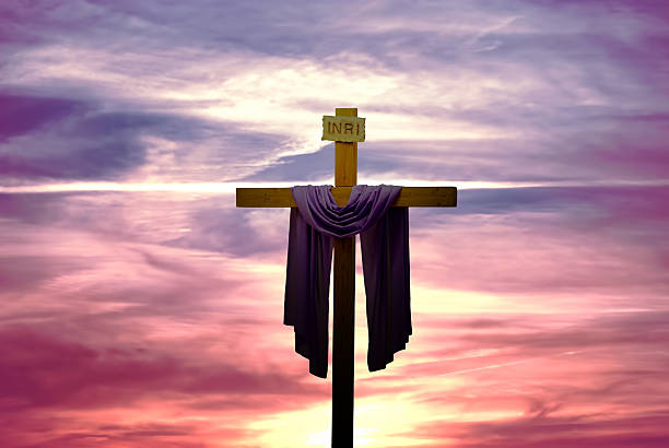 istock Christian cross over bright sunset background 584765668