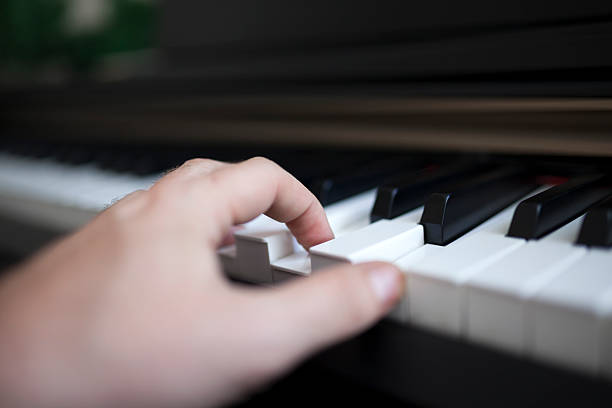 istock Close-up pianist hand on piano 584767242