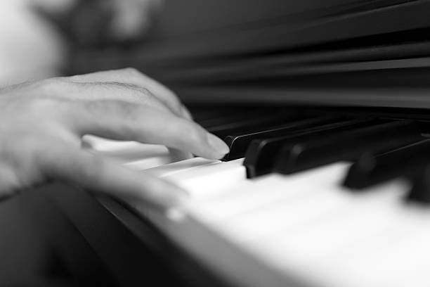 istock Close-up pianist hand on piano 584767340