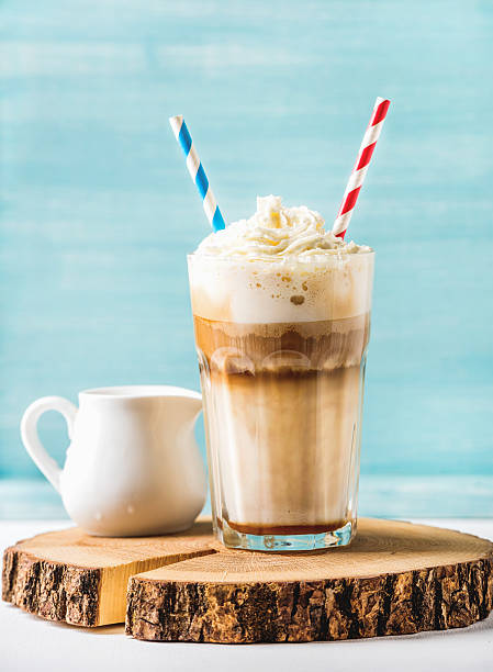 istock Latte macchiato with whipped cream in tall glass and pitcher 584769232