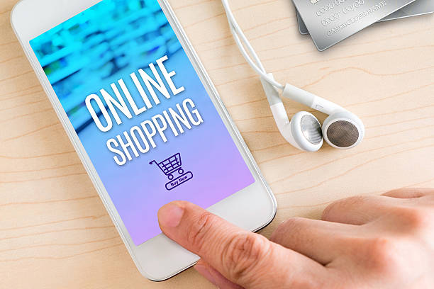 istock Hand touch smart phone and ear phone with Online shopping 584769524