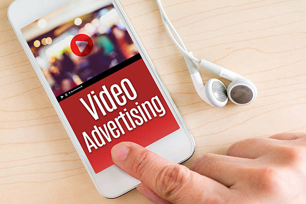 istock Hand touch smart phone and ear phone with Video Advertising 584769572
