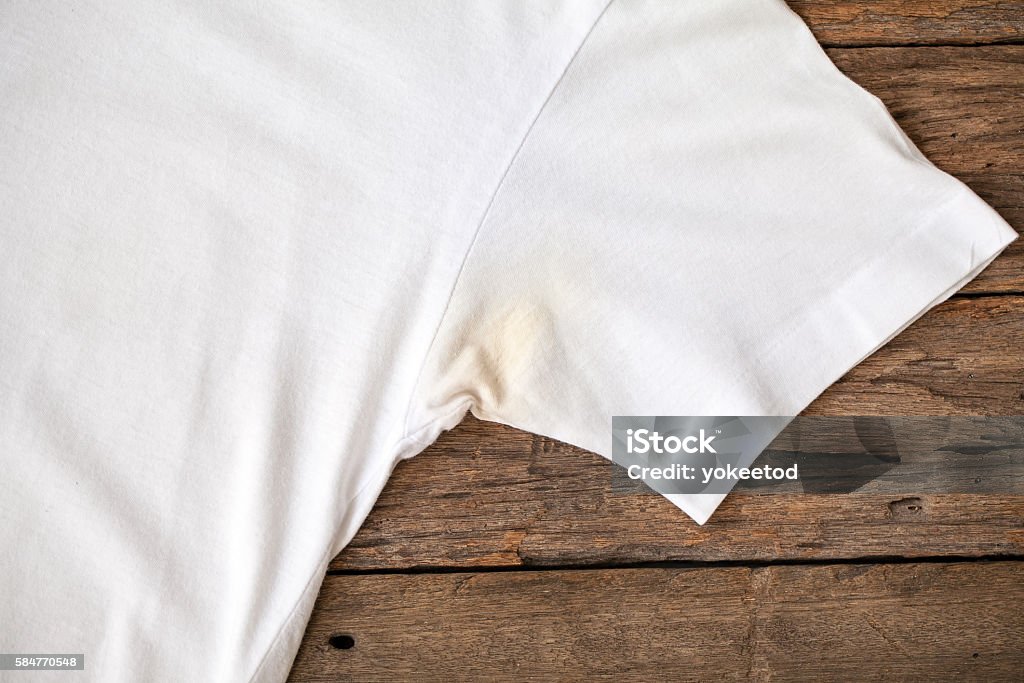 Shirts dirty caused by roll- on Shirts dirty caused by roll- on deodorant on wooden background Applying Stock Photo