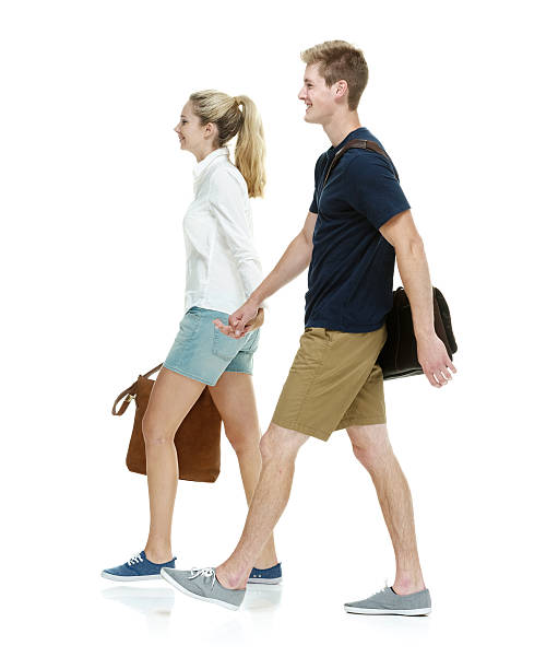 istock Happy students holding hands and walking 584771102