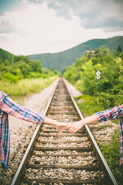 istock Couple walking on railroad 584772530