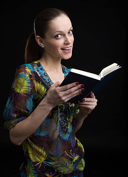 istock young woman reading a book 584772850