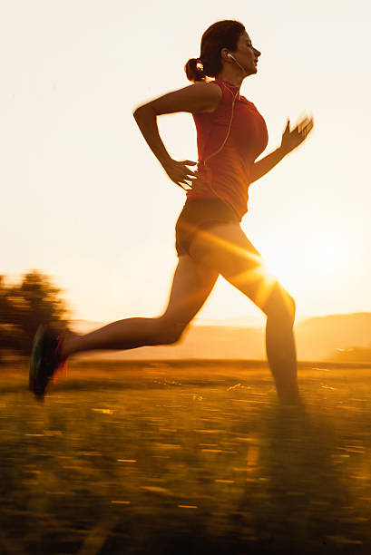 istock Young Woman Running Outdoors at Sunset 584773092