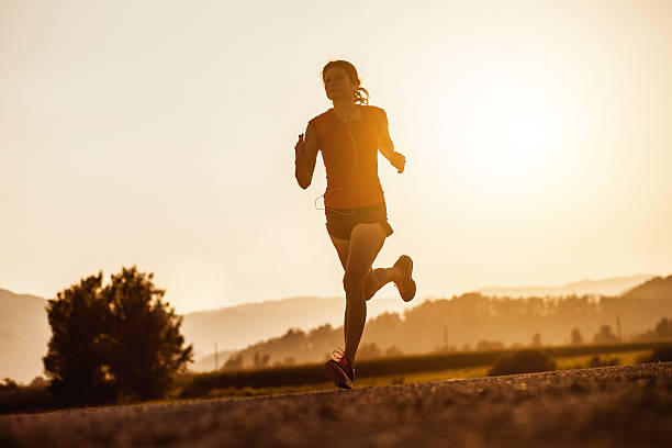istock Young Woman Running Outdoors at Sunset 584773278