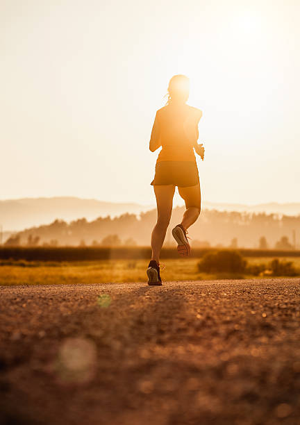 Young Woman Running Outdoors at Sunset