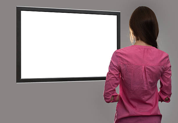 istock woman looking at blank tv screen 584775508