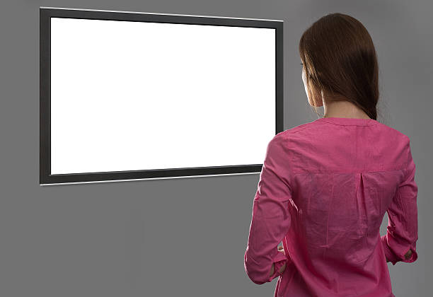 istock woman looking at blank tv screen 584775544