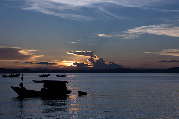 istock Boats resting on a beautiful sunset at the beach 584775628
