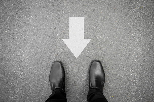 Black shoes and direction sign backward