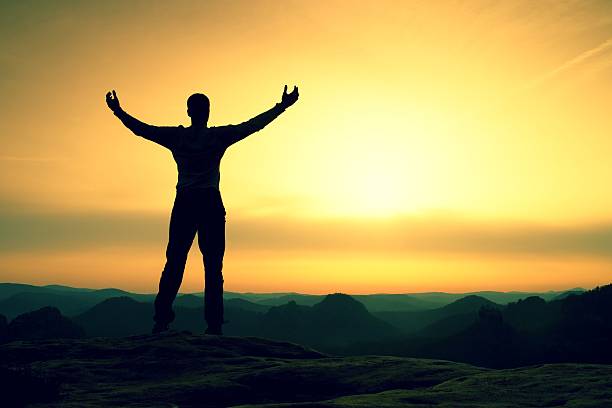 istock Happy man with open raised arms Satisfy hiker  silhouette 584776002