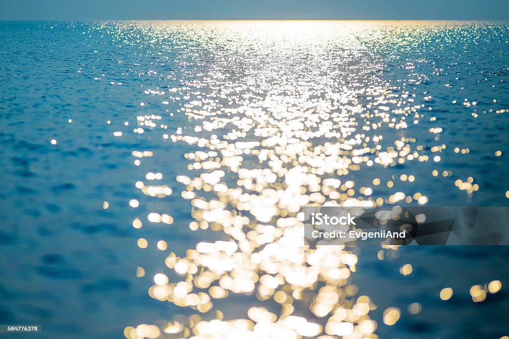 water horizon at sunset water horizon filled with light of the setting sun. blur reflection on the sea, golden sunlight Water Stock Photo
