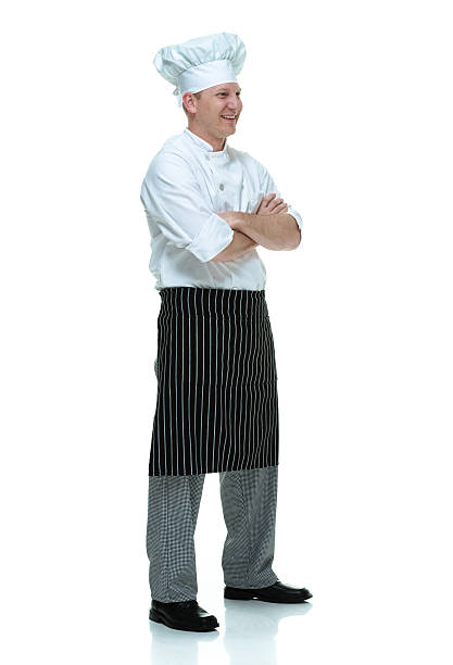 istock Smiling chef standing with arms crossed 584776718