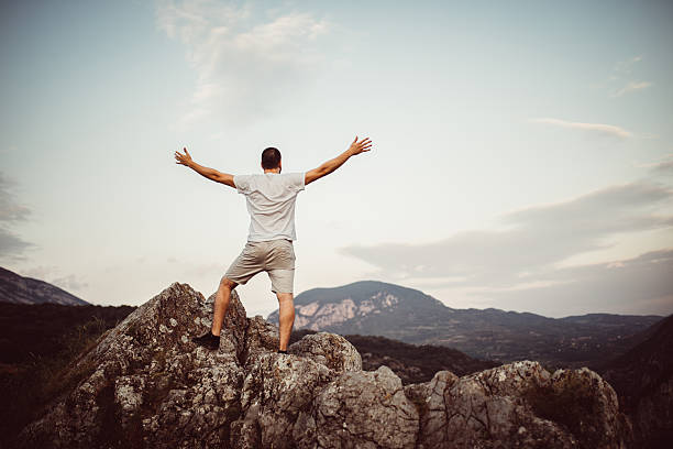 istock Man lifts  arms in victory 584777016